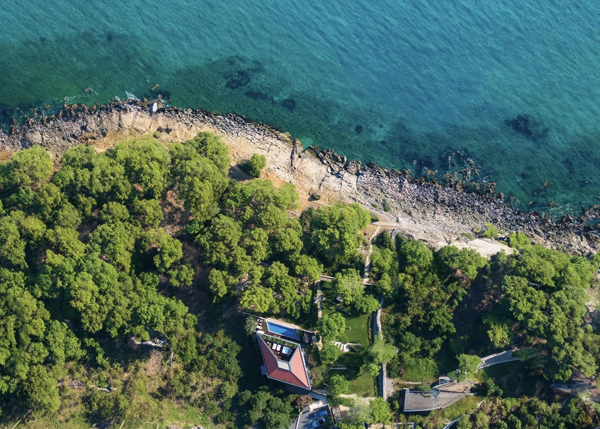The villa on its rocky coastline, from the air