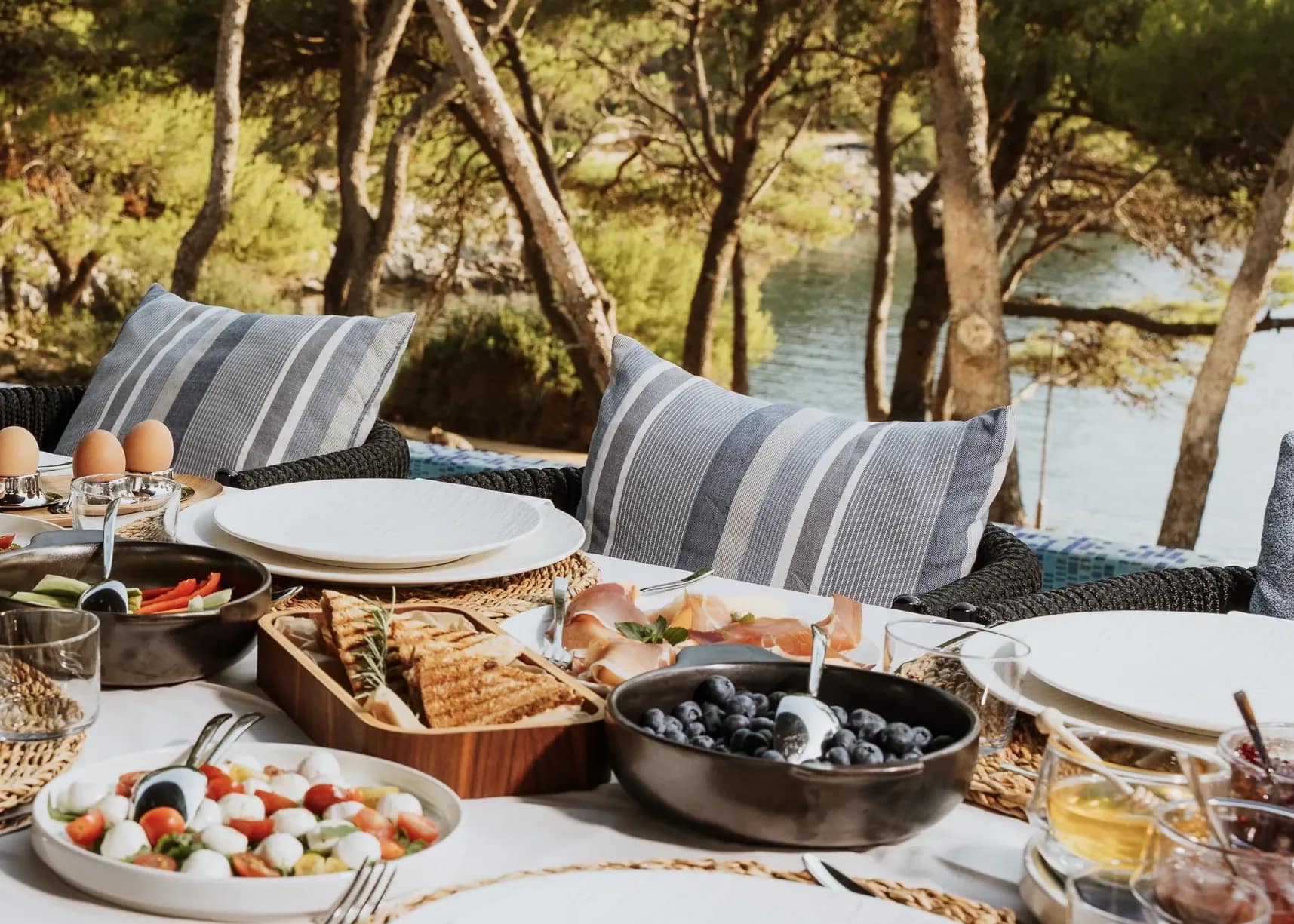 Breakfast laid among the pines, above the sea