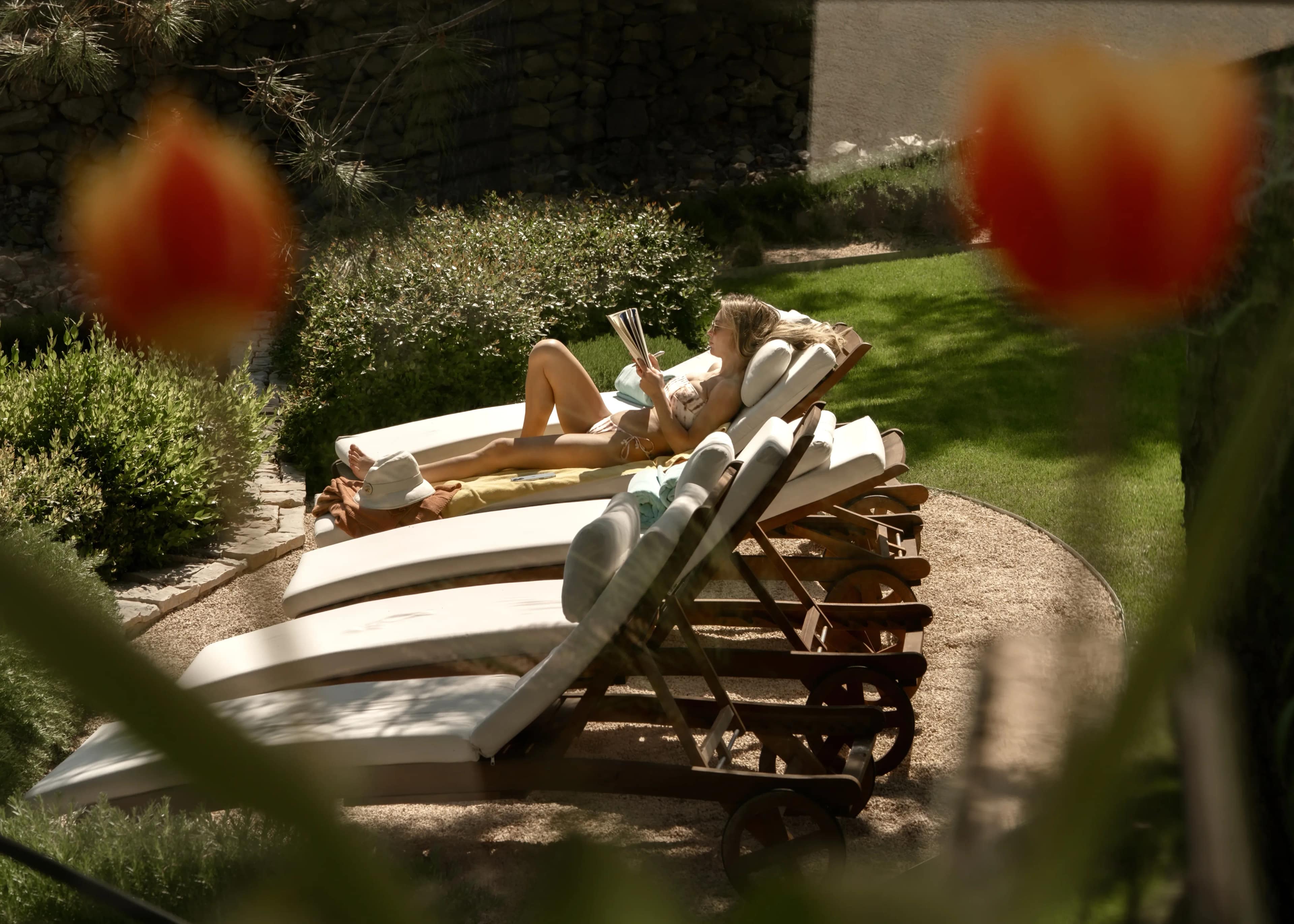 Loungers on the lawn, seen through the tulips