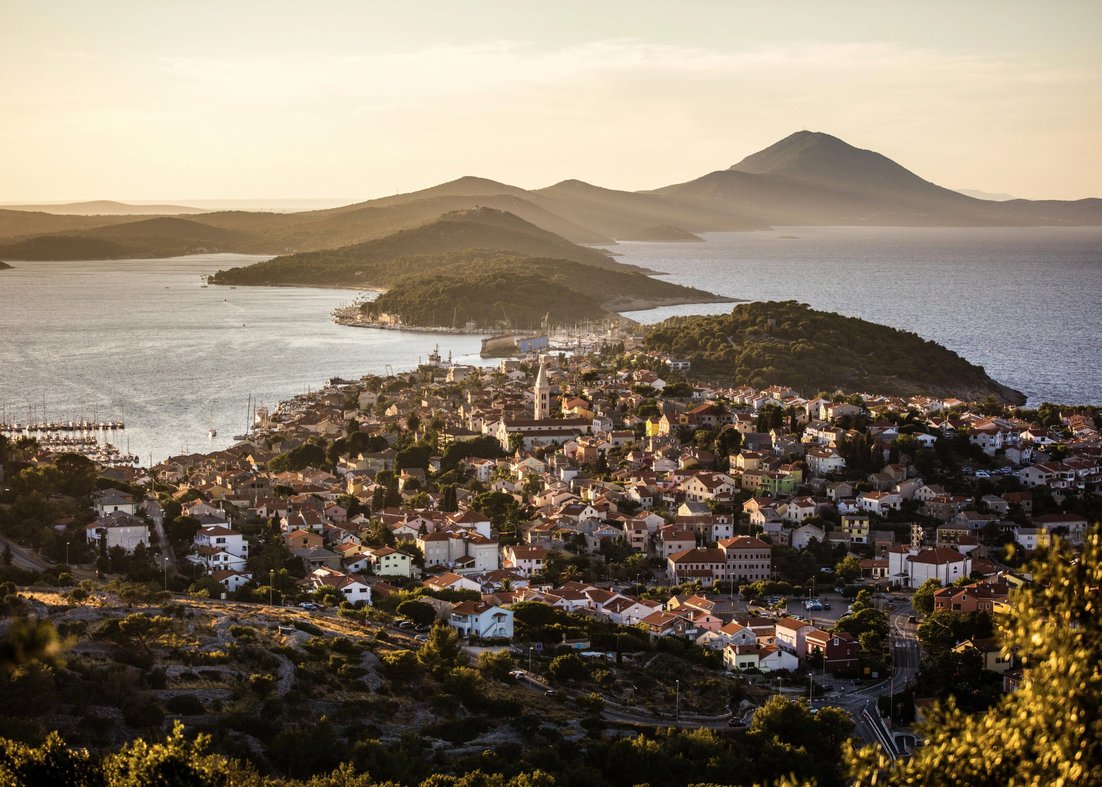 Aerial of Mali Lošinj town and harbour at sunset