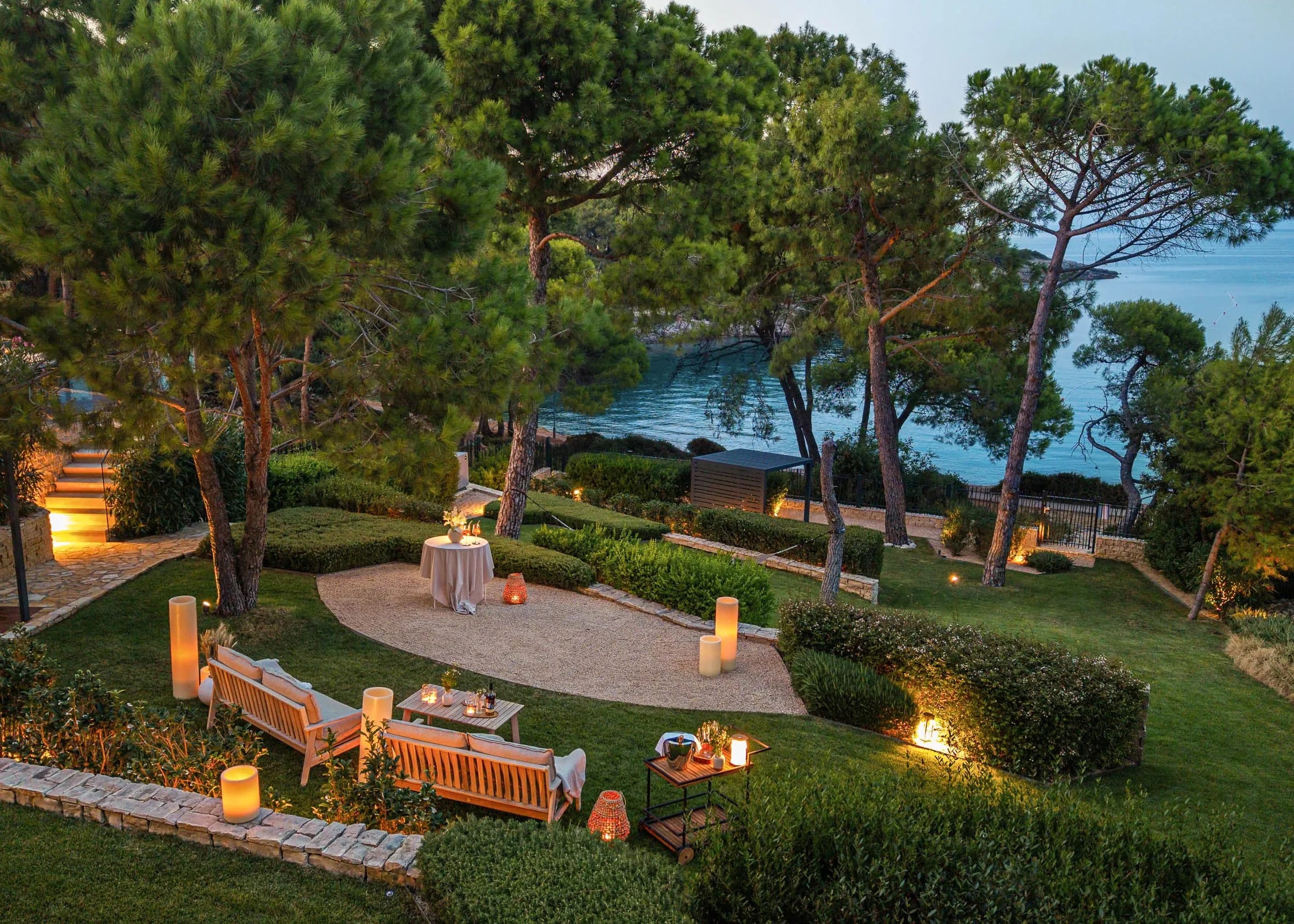 The garden at night, lanterns and candlelight along the path to the sea