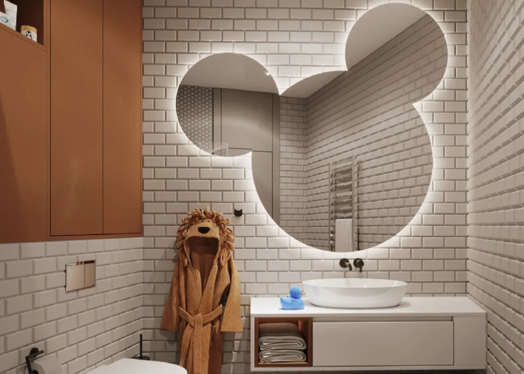 The children's bathroom — Mickey Mouse mirror, lion-hooded robe, double trough sink