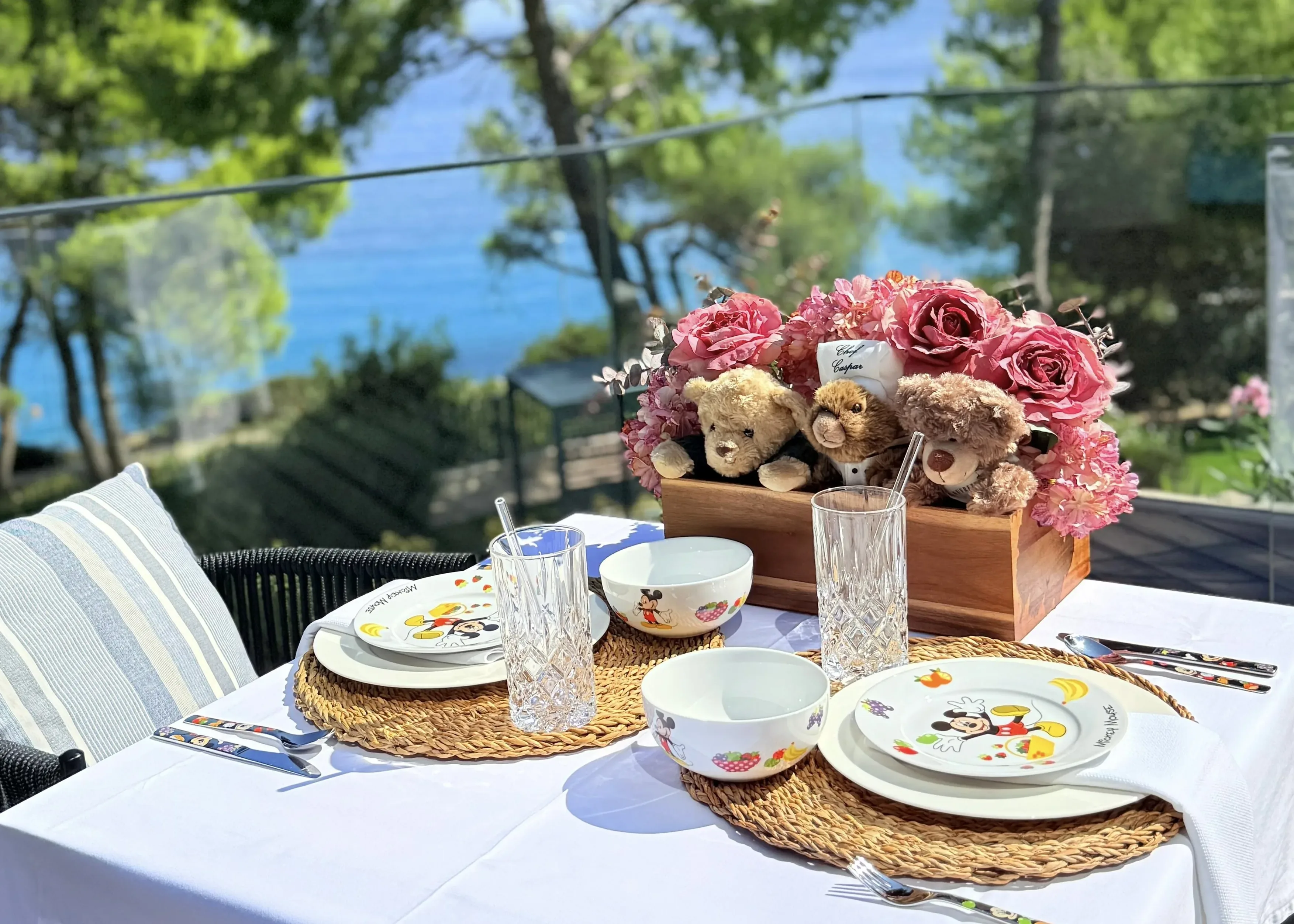 The children's breakfast table — Mickey plates, teddy bears, fresh juice