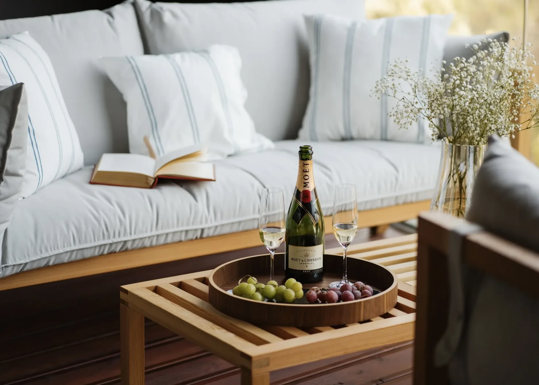Spiridon suite — Moët and grapes on the tray, the terrace sofa beyond