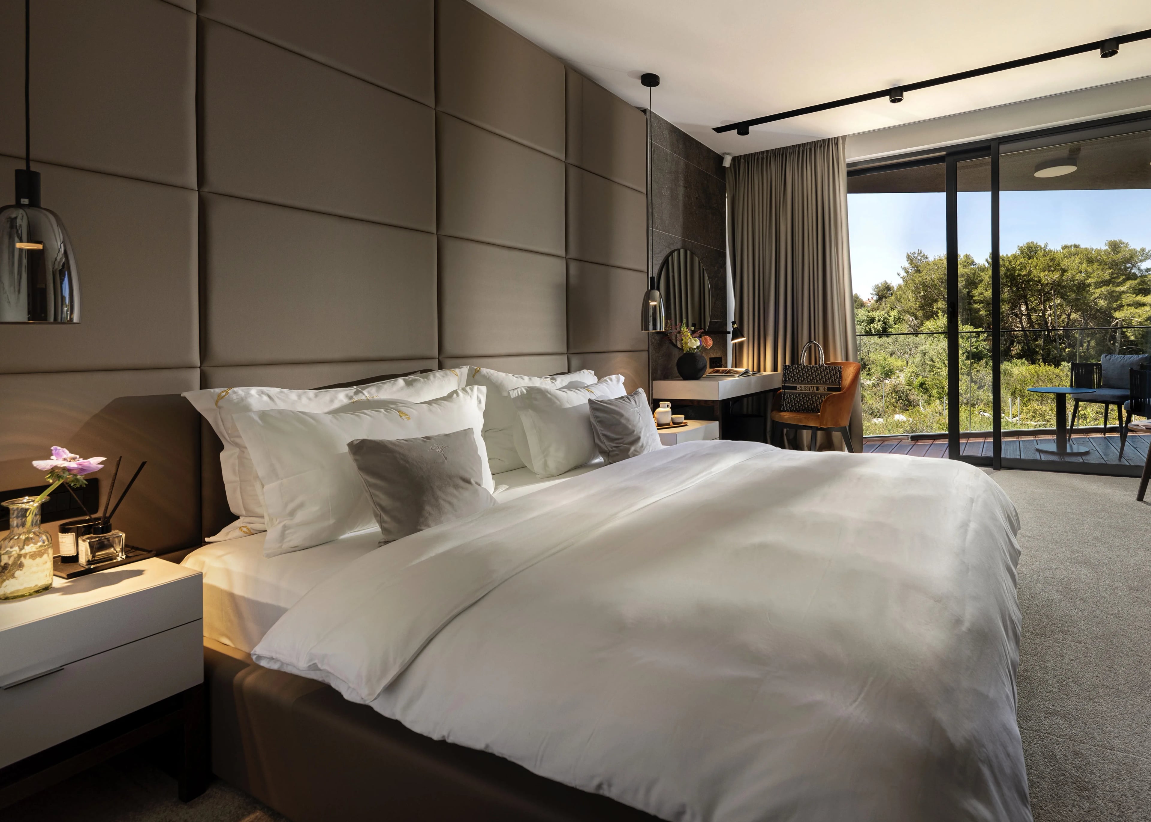 Ambroz — the suite from the foot of the bed, balcony beyond