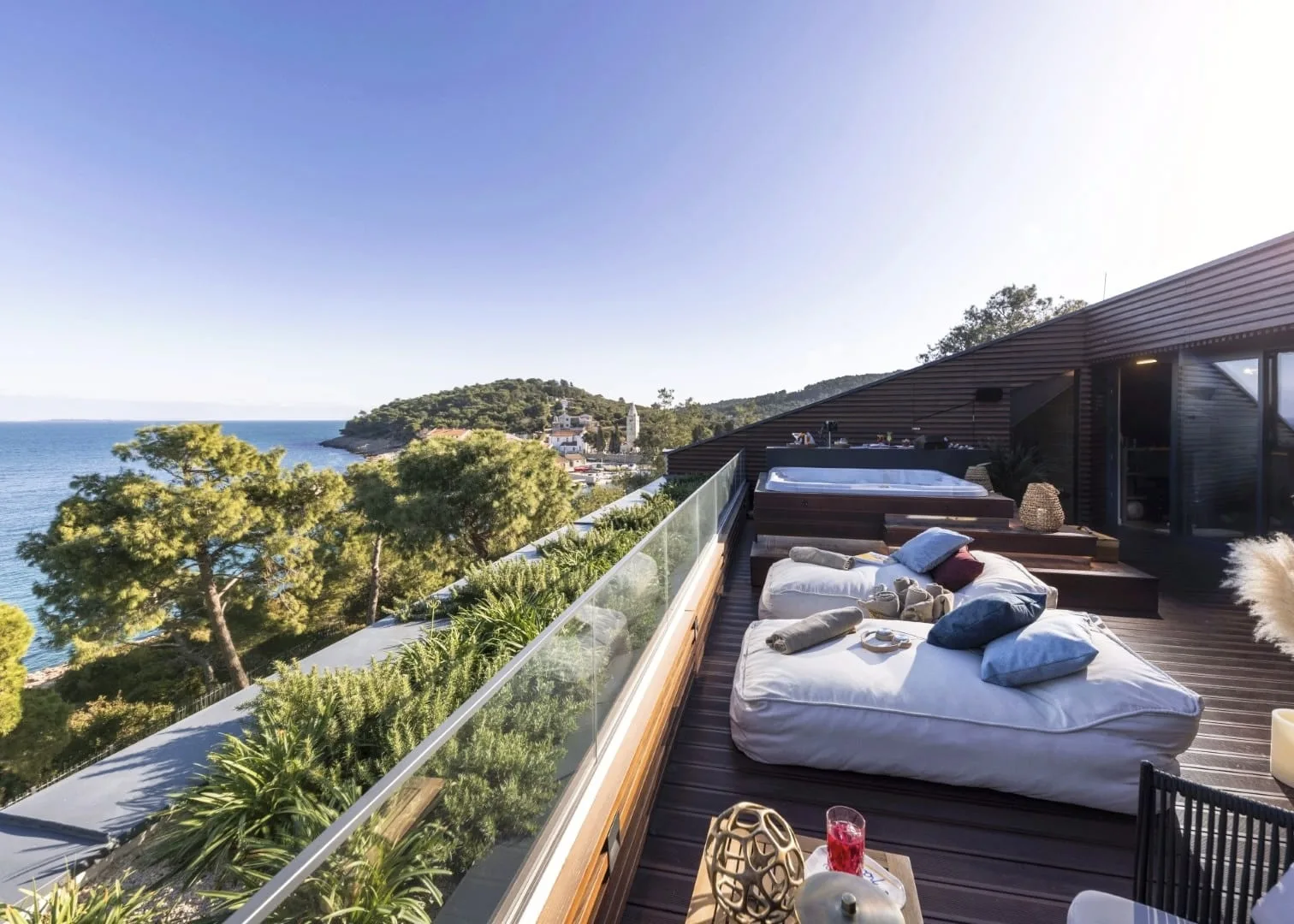 Rooftop daybeds looking out over the cove and the island beyond