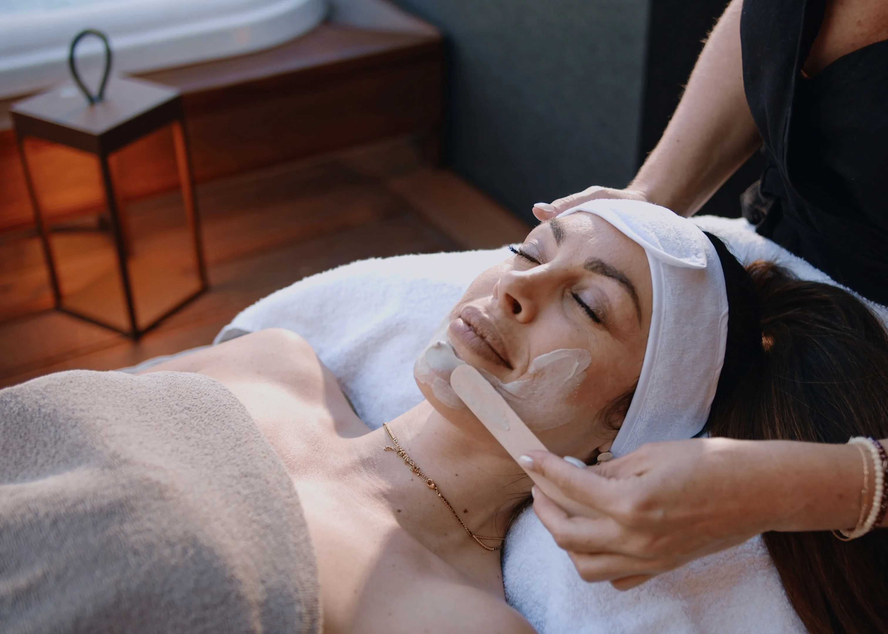 A guest receiving an in-villa facial treatment