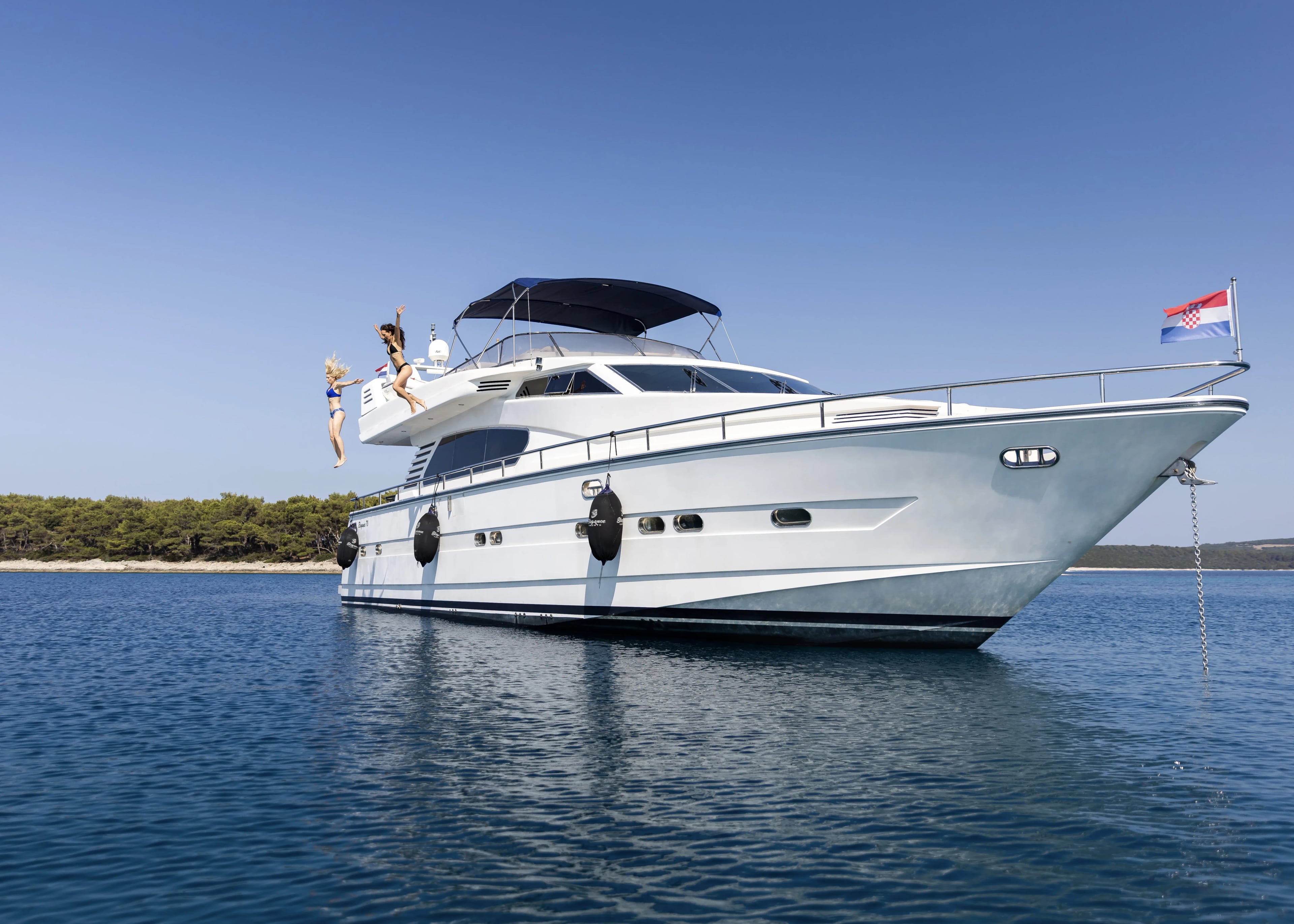 Guests jumping from the upper deck of the yacht into the Adriatic